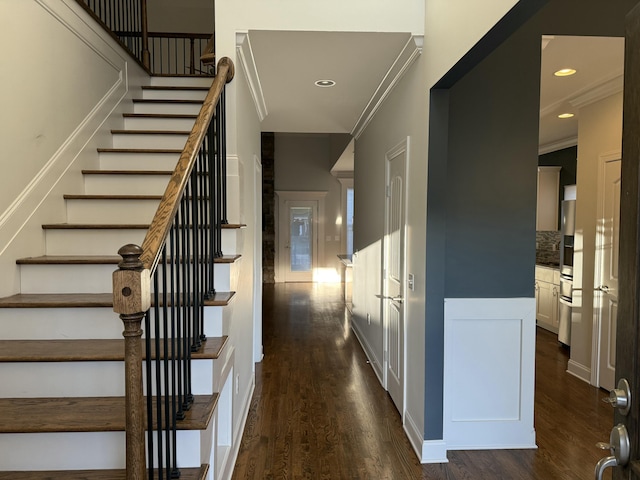 stairs featuring crown molding and hardwood / wood-style flooring