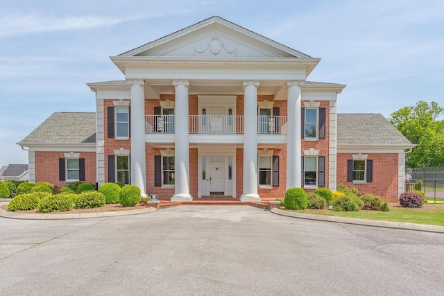 neoclassical home with a balcony