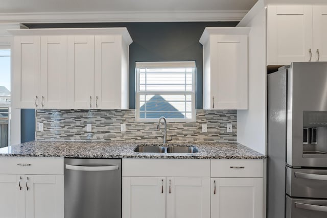 kitchen with sink, stainless steel appliances, and white cabinets