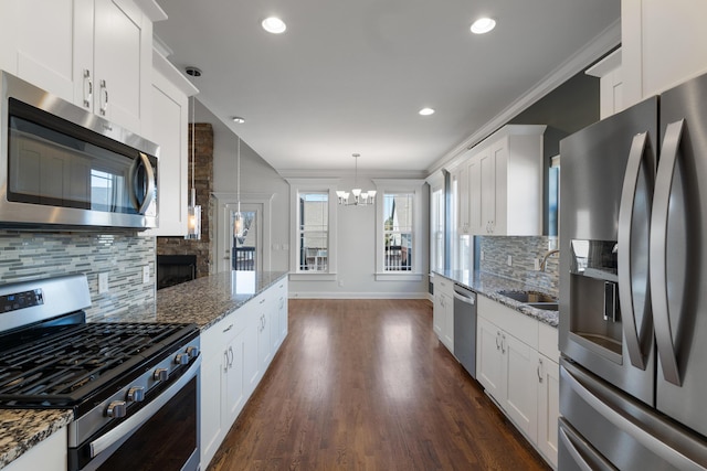 kitchen featuring appliances with stainless steel finishes, sink, and white cabinets