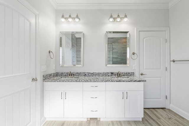 bathroom featuring ornamental molding, vanity, hardwood / wood-style floors, and a shower