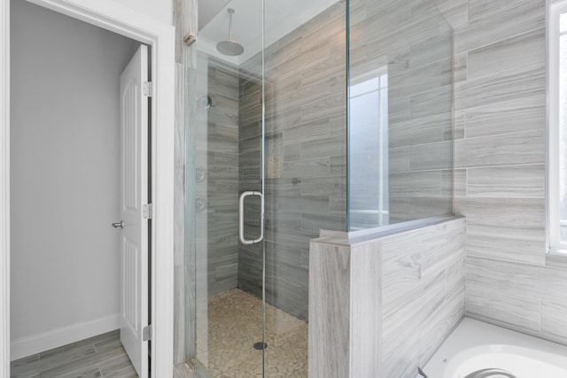 bathroom featuring separate shower and tub