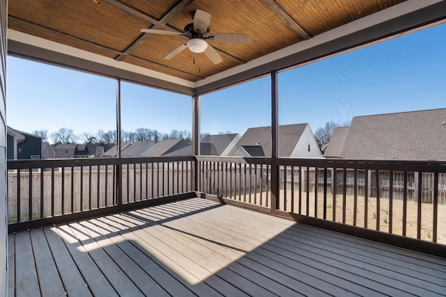 sunroom featuring ceiling fan and wood ceiling