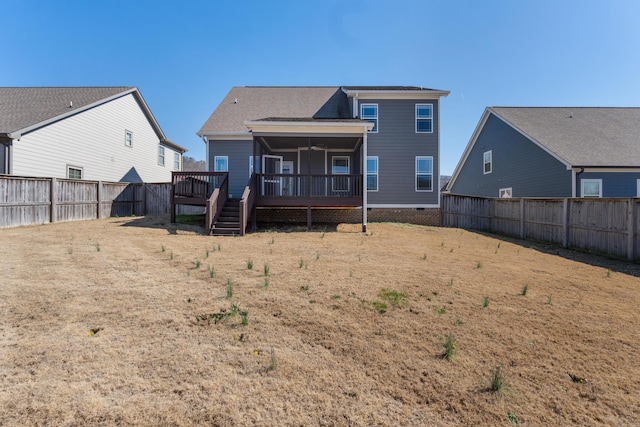 rear view of property featuring a yard and a deck