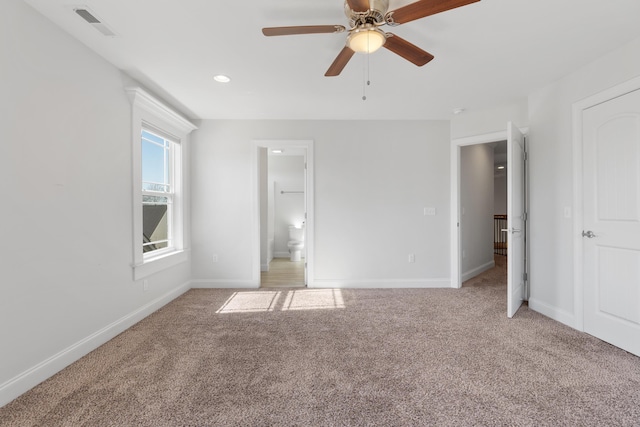 carpeted empty room featuring ceiling fan