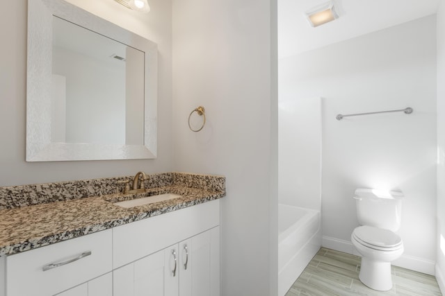 bathroom featuring wood-type flooring, vanity, and toilet