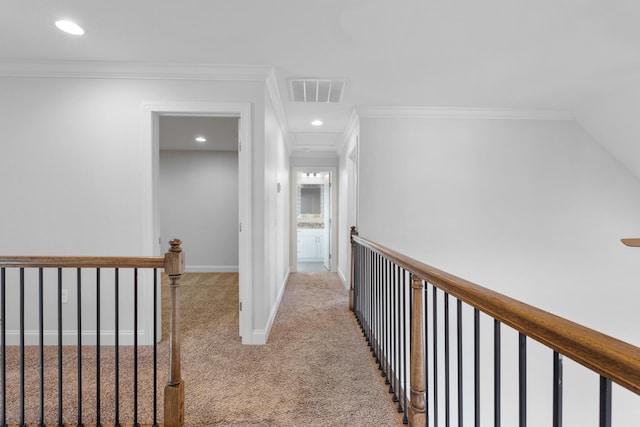 corridor with crown molding and light carpet