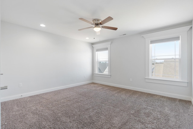 carpeted empty room featuring ceiling fan