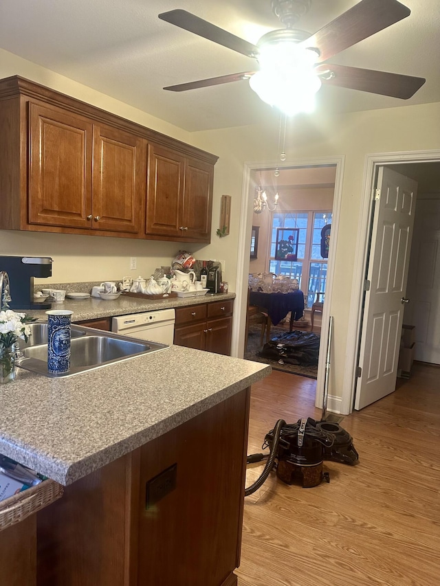 kitchen featuring sink, dishwasher, ceiling fan, and light wood-type flooring