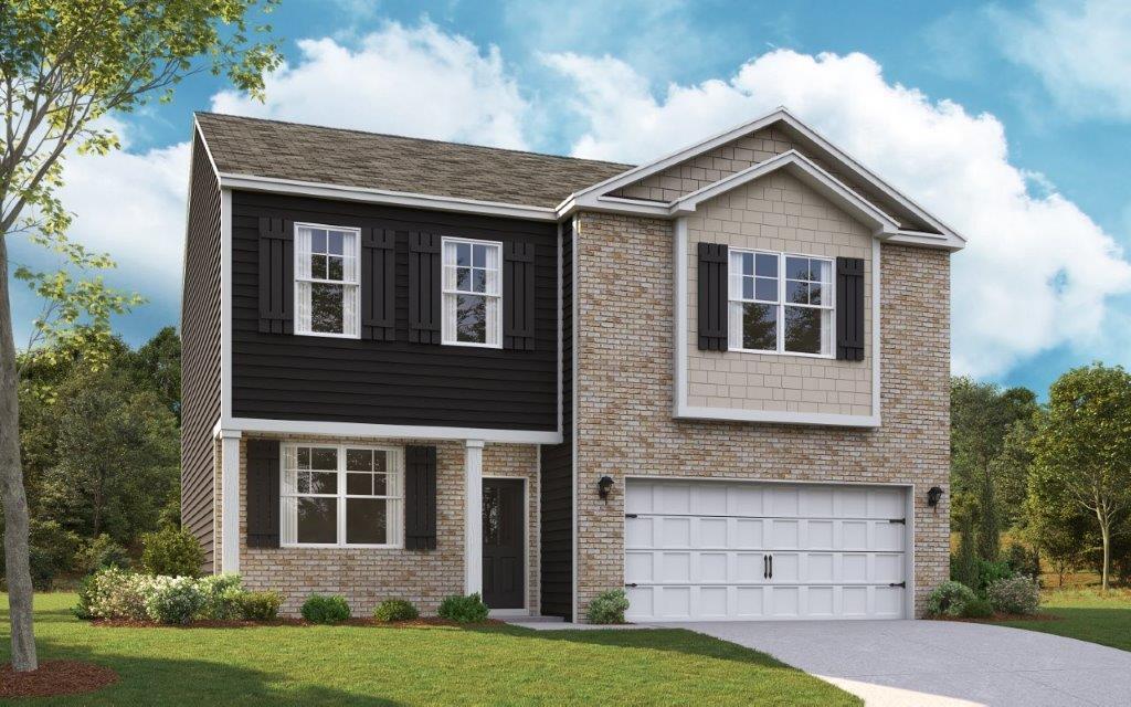 view of front of house featuring a garage and a front lawn