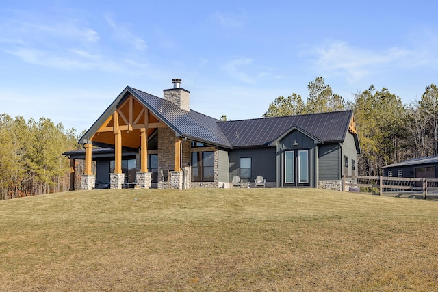 back of house featuring a lawn