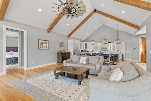 living room with beam ceiling, high vaulted ceiling, light wood-type flooring, and ceiling fan