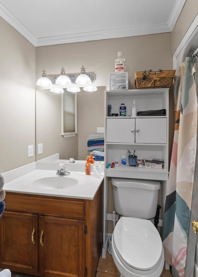 bathroom featuring tile patterned flooring, ornamental molding, vanity, and toilet