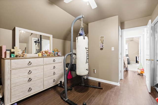 exercise room featuring wood-type flooring, vaulted ceiling, and ceiling fan