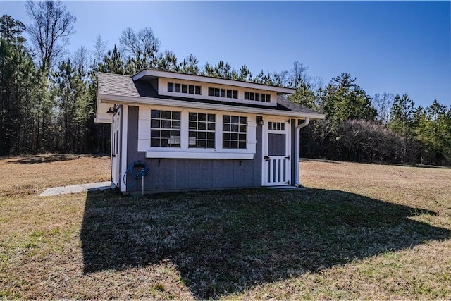 view of outbuilding with a yard