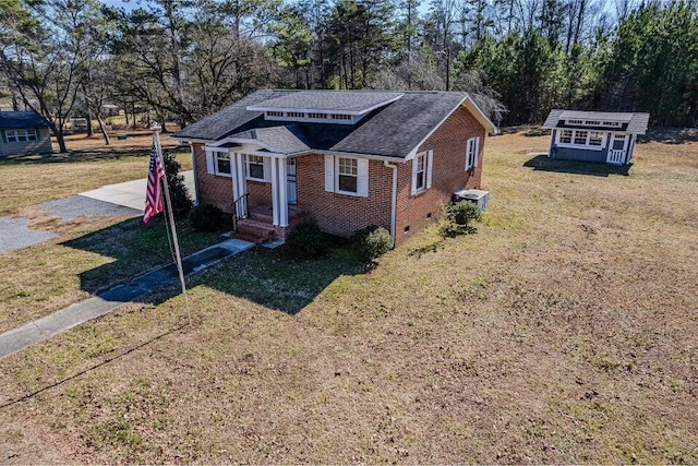 view of front of house featuring a front yard and a storage unit