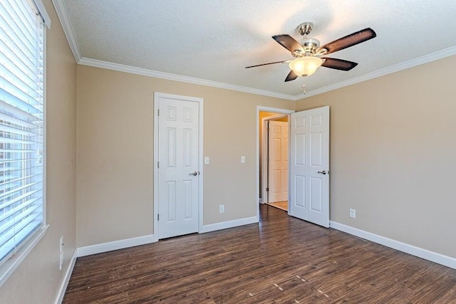 unfurnished bedroom featuring a textured ceiling, dark wood-type flooring, ornamental molding, and ceiling fan