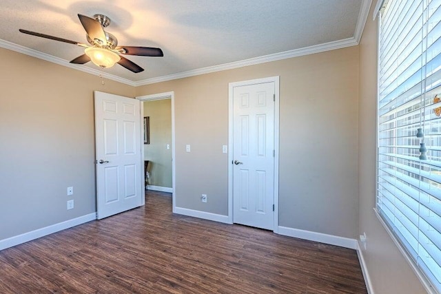 unfurnished bedroom with dark wood-type flooring, ornamental molding, and ceiling fan