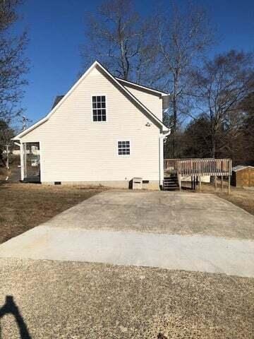 view of side of home with a deck