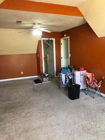 bonus room featuring lofted ceiling, a textured ceiling, carpet, and ceiling fan