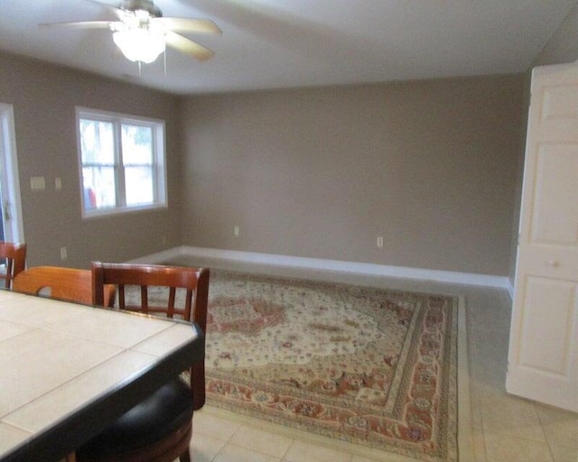 bedroom with light tile patterned floors and ceiling fan