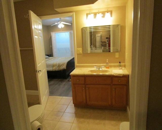 bathroom featuring ceiling fan, vanity, toilet, and tile patterned flooring