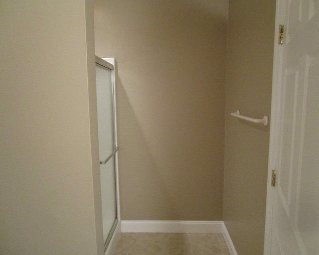 spacious closet with light tile patterned floors