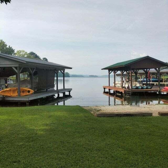 dock area featuring a water view and a yard