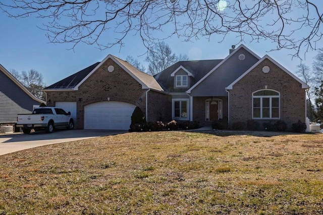 view of property with a garage and a front lawn