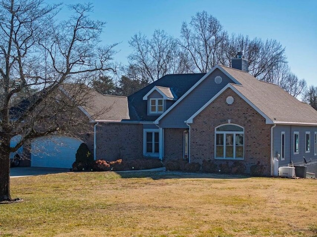 view of front of home with a garage, a front lawn, and central air condition unit