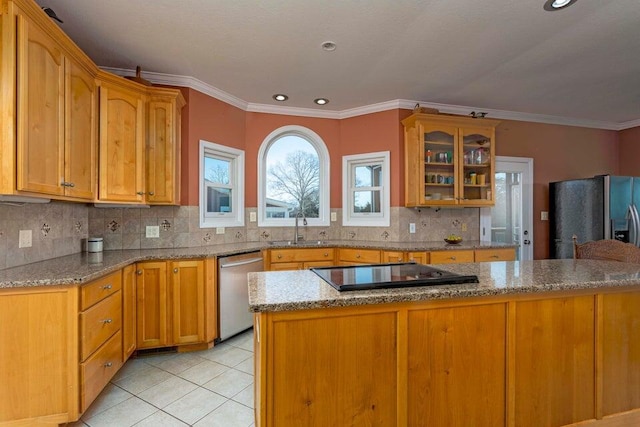 kitchen featuring appliances with stainless steel finishes, light stone countertops, sink, and light tile patterned floors