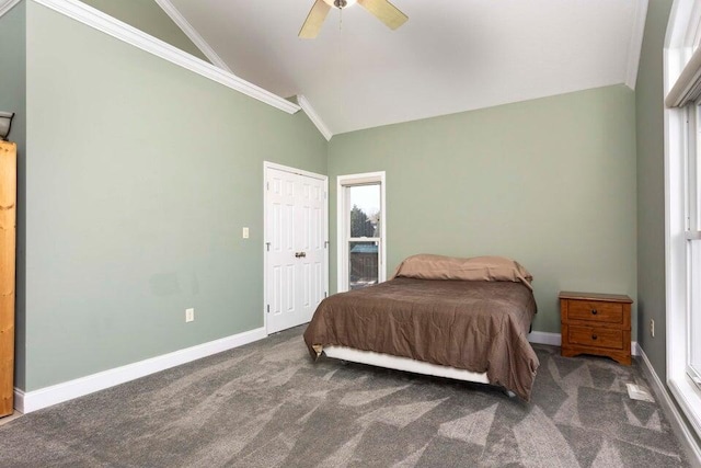 carpeted bedroom featuring crown molding, vaulted ceiling, and ceiling fan