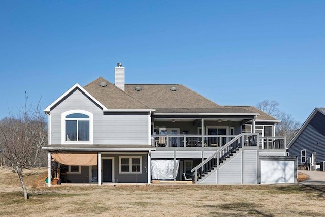 back of property with a sunroom and a lawn