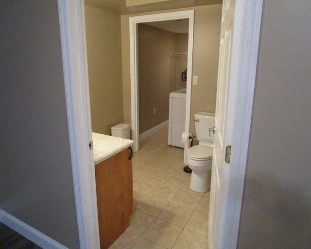 bathroom with vanity, washer / clothes dryer, tile patterned floors, and toilet