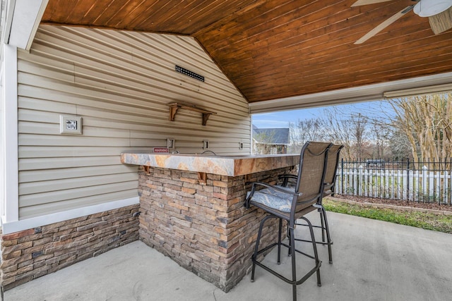 view of patio / terrace with an outdoor bar and ceiling fan