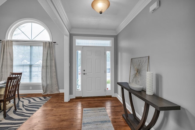 entrance foyer featuring crown molding and dark wood-type flooring