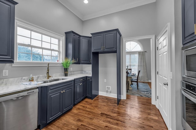 kitchen featuring ornamental molding, stainless steel appliances, dark hardwood / wood-style floors, and a wealth of natural light