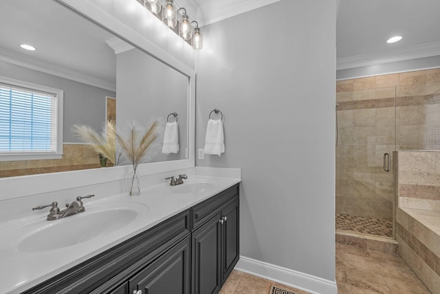 bathroom featuring an enclosed shower, vanity, crown molding, and tile patterned floors