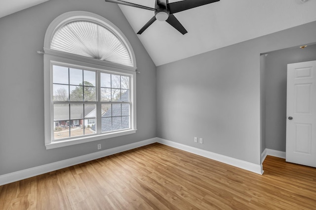 spare room featuring ceiling fan, lofted ceiling, and light hardwood / wood-style flooring