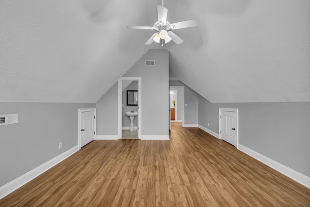 bonus room featuring ceiling fan, lofted ceiling, and light wood-type flooring