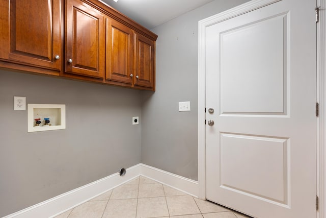 laundry area featuring cabinets, washer hookup, hookup for an electric dryer, and light tile patterned floors