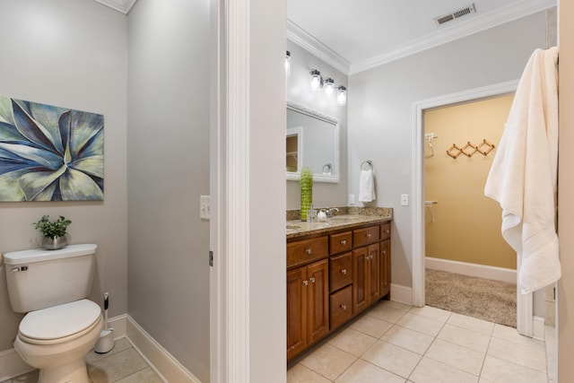 bathroom with crown molding, vanity, toilet, and tile patterned flooring