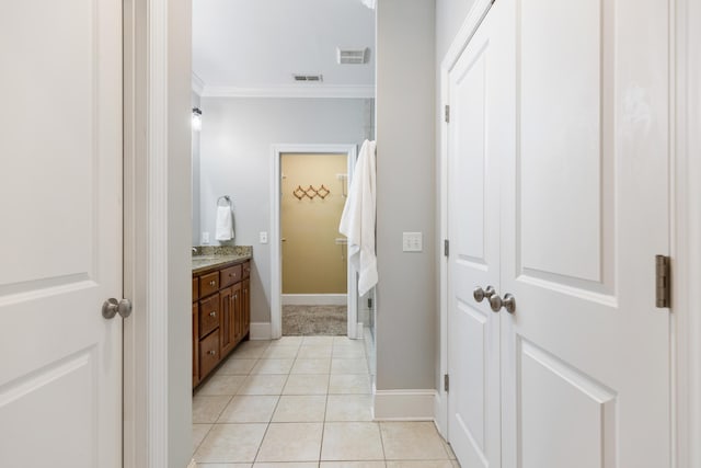 bathroom with tile patterned flooring, vanity, and crown molding