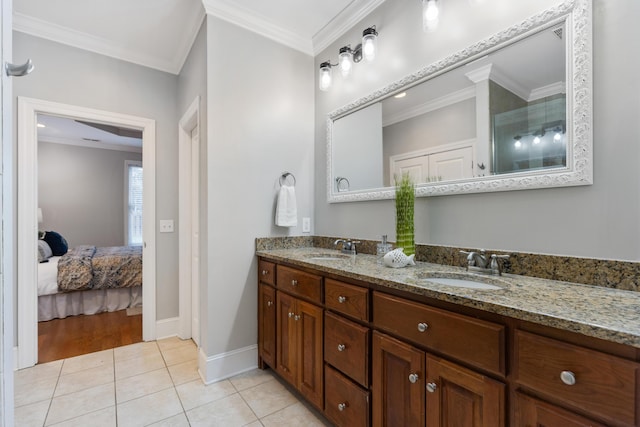 bathroom with crown molding, tile patterned floors, and vanity