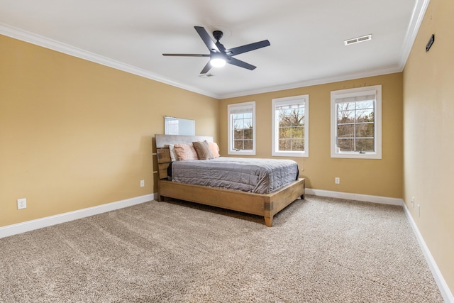 carpeted bedroom featuring crown molding and ceiling fan