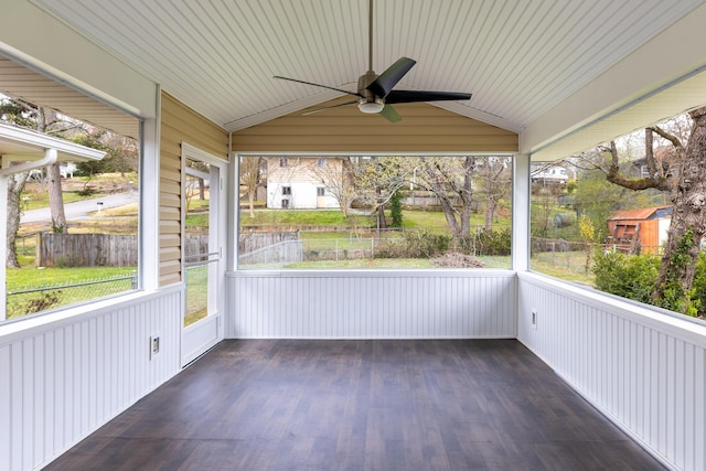 unfurnished sunroom with ceiling fan and vaulted ceiling