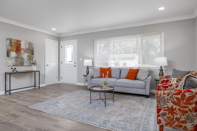 living area with recessed lighting, ornamental molding, baseboards, and wood finished floors