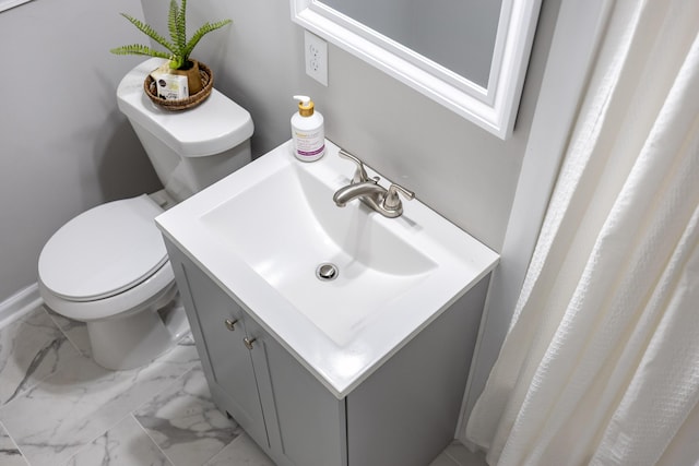 bathroom with baseboards, marble finish floor, vanity, and toilet