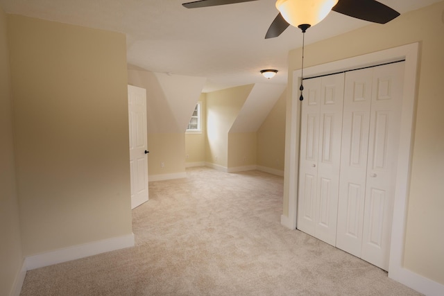 bonus room with lofted ceiling, light colored carpet, and ceiling fan