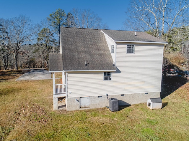 back of house featuring cooling unit, a patio, and a lawn